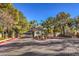 Community entrance with manicured landscaping and brick-paved streets at 8408 Running Deer Ave # 201, Las Vegas, NV 89145