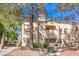 Charming two-story stucco building with red tile roof and desert landscaping at 8408 Running Deer Ave # 201, Las Vegas, NV 89145
