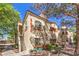 Attractive two-story stucco building with red tile roof and desert landscaping at 8408 Running Deer Ave # 201, Las Vegas, NV 89145