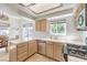 Well-lit kitchen featuring white tile countertops, wood cabinets and stainless steel appliances at 8408 Running Deer Ave # 201, Las Vegas, NV 89145