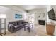 Bright living room with gray sofa, fireplace, and sliding glass doors to balcony at 8408 Running Deer Ave # 201, Las Vegas, NV 89145