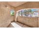 Covered outdoor patio with arched windows, offering a view of the surrounding landscape at 8408 Running Deer Ave # 201, Las Vegas, NV 89145