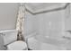 Clean and bright bathroom with a bathtub, white tiles, and modern fixtures at 950 Seven Hills Dr # 124, Henderson, NV 89052