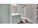 Updated bathroom with modern fixtures and a floral shower curtain at 950 Seven Hills Dr # 124, Henderson, NV 89052