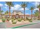 Clubhouse entrance with manicured landscaping, mature trees, and inviting walkway at 950 Seven Hills Dr # 124, Henderson, NV 89052