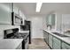 Modern kitchen featuring stainless steel appliances, sleek countertops, and stylish green cabinetry at 950 Seven Hills Dr # 124, Henderson, NV 89052