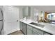 A well-appointed kitchen with stainless steel appliances, sleek white countertops, and stylish green cabinetry at 950 Seven Hills Dr # 124, Henderson, NV 89052