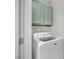 Compact laundry closet featuring a stacked washer and dryer unit at 950 Seven Hills Dr # 124, Henderson, NV 89052