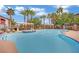 Large community pool area featuring palm trees, lounge chairs, and spa at 950 Seven Hills Dr # 124, Henderson, NV 89052