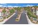 Community street with palm trees and a view of well-maintained townhomes in a desert environment at 950 Seven Hills Dr # 124, Henderson, NV 89052