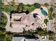 Stunning aerial view of sprawling estate, manicured lawns, lush landscaping, luxurious pool, and decorative tile roof at 9533 Orient Express Ct, Las Vegas, NV 89145