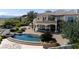 Inviting backyard with pool, covered patio with plenty of room for entertaining, and beautiful landscaping at 9533 Orient Express Ct, Las Vegas, NV 89145