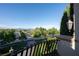 Scenic view from a balcony overlooking a well-manicured neighborhood with lush trees and clear blue sky at 9533 Orient Express Ct, Las Vegas, NV 89145