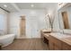 Luxurious bathroom with a soaking tub, dual vanity sinks, and a separate walk-in shower at 9533 Orient Express Ct, Las Vegas, NV 89145