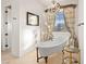 Charming bathroom featuring a clawfoot tub, stained glass window, and ornate decor at 9533 Orient Express Ct, Las Vegas, NV 89145