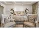 Cozy bedroom featuring two chairs, a comfortable bed, and decorative mirrors at 9533 Orient Express Ct, Las Vegas, NV 89145