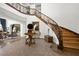 Grand foyer showcasing a winding staircase, decorative table, and views into the living room at 9533 Orient Express Ct, Las Vegas, NV 89145
