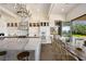 A gourmet kitchen with an oversized island, luxury appliances, and an adjacent dining space at 9533 Orient Express Ct, Las Vegas, NV 89145