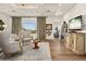 Comfortable living room with large window, hardwood floors, and elegant furnishings at 9533 Orient Express Ct, Las Vegas, NV 89145