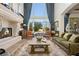 Elegant living room with a cozy fireplace, large windows, and stylish furnishings for comfortable living at 9533 Orient Express Ct, Las Vegas, NV 89145