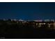 Las Vegas skyline illuminated at night provides the backdrop to this home at 9533 Orient Express Ct, Las Vegas, NV 89145