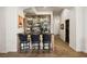 Custom wet bar featuring mirrored backsplash, seating, and ample storage for beverages and glassware at 9533 Orient Express Ct, Las Vegas, NV 89145