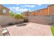 A beautiful backyard, featuring a brick fence, cozy seating, and vibrant plants and grass at 9785 Iron Mine St, Las Vegas, NV 89183