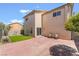 Spacious backyard with a brick patio, chairs, and artificial grass at 9785 Iron Mine St, Las Vegas, NV 89183