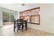 Bright breakfast nook with tile flooring, black chairs, and view to the backyard at 9785 Iron Mine St, Las Vegas, NV 89183