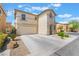 Two-story home with neutral stucco, red tile roof, and spacious driveway at 9785 Iron Mine St, Las Vegas, NV 89183