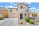 Traditional two-story home with an attached two-car garage and manicured landscaping at 9785 Iron Mine St, Las Vegas, NV 89183