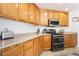 Well-lit kitchen featuring stainless steel appliances and neutral-colored countertops at 9785 Iron Mine St, Las Vegas, NV 89183