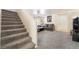 Spacious living room with neutral walls, plush carpeting, and a staircase at 9785 Iron Mine St, Las Vegas, NV 89183