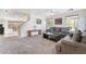 Inviting living room with plush carpeting, neutral walls, and ample natural light at 9785 Iron Mine St, Las Vegas, NV 89183