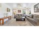 Bright living room featuring plush carpeting, two sofas, and large windows at 9785 Iron Mine St, Las Vegas, NV 89183