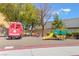 Community playground with colorful train and bus play structures at 9785 Iron Mine St, Las Vegas, NV 89183