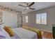 Charming bedroom with patterned wallpaper, ceiling fan, and natural light at 9992 Sky Parlor Rd, Las Vegas, NV 89178