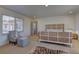 Bright bedroom featuring a unique rattan bed frame, plush carpet, and stylish accent chair at 9992 Sky Parlor Rd, Las Vegas, NV 89178