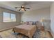 Comfortable bedroom with ceiling fan, window with blinds, and a cozy rug at 9992 Sky Parlor Rd, Las Vegas, NV 89178
