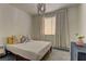 Cozy bedroom with warm textiles, natural lighting, and a decorative chandelier at 9992 Sky Parlor Rd, Las Vegas, NV 89178