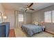 Inviting bedroom featuring wood floors, natural light, and blue accents at 9992 Sky Parlor Rd, Las Vegas, NV 89178