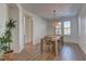 Cozy dining room with natural light, stylish chandelier, and warm wood floors at 9992 Sky Parlor Rd, Las Vegas, NV 89178
