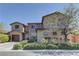 Stunning two-story home with a combination of stone and stucco, plus a well-manicured yard at 9992 Sky Parlor Rd, Las Vegas, NV 89178