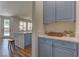 Charming kitchen area with wood floors, marble countertops, and modern lighting at 9992 Sky Parlor Rd, Las Vegas, NV 89178