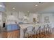 Spacious kitchen boasts a large island with seating, stainless steel appliances, and wood floors at 9992 Sky Parlor Rd, Las Vegas, NV 89178