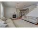 Cozy living room with fireplace and staircase at 9992 Sky Parlor Rd, Las Vegas, NV 89178