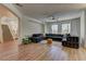 Spacious living room featuring wood floors and a comfortable sectional sofa at 9992 Sky Parlor Rd, Las Vegas, NV 89178