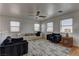 Bright, open living area features a ceiling fan, modern furniture, and a patterned rug at 9992 Sky Parlor Rd, Las Vegas, NV 89178