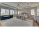 Spacious main bedroom with a tray ceiling, large windows, and a sitting area at 9992 Sky Parlor Rd, Las Vegas, NV 89178