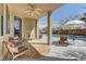 Covered patio overlooking a sparkling pool with comfortable seating and shade at 9992 Sky Parlor Rd, Las Vegas, NV 89178